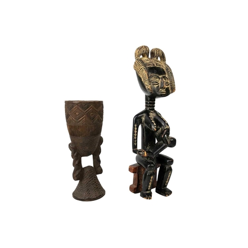 224 - An Akan wood carved maternity figure. With white pigment, height 37cm, together with an African wood... 