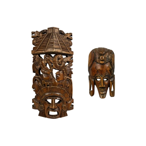 227 - An Aztec style carved wood mask. Carved with a stepped pyramid above figures, length 45cm together w... 