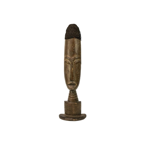 228 - An African wood carved tall bust. With applied fibre coiffure, height 68cm.