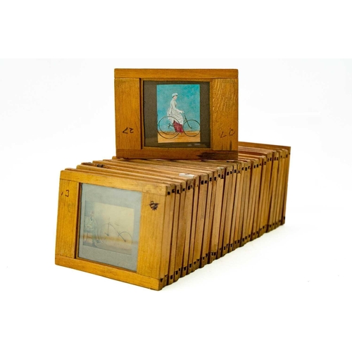 24 - A collection of 33 magic lantern slides. Depicting the History of the bicycle with a laminated list ... 