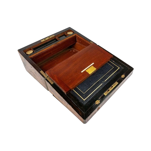 257 - A Victorian burr walnut and brass bound writing slope. The fitted interior with leather skiver and t... 