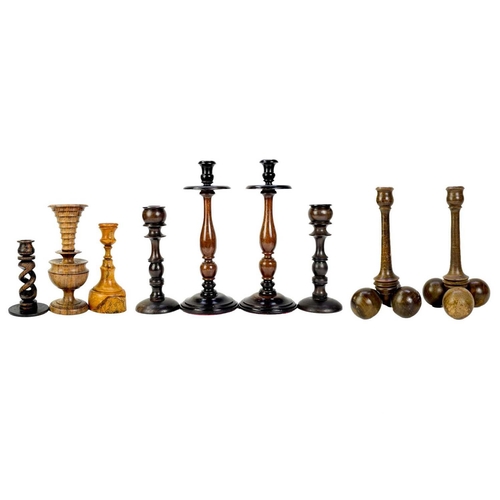 260 - A collection of nine treen candlesticks. Tallest 34cm. (9) Generally good condition with no breaks o... 