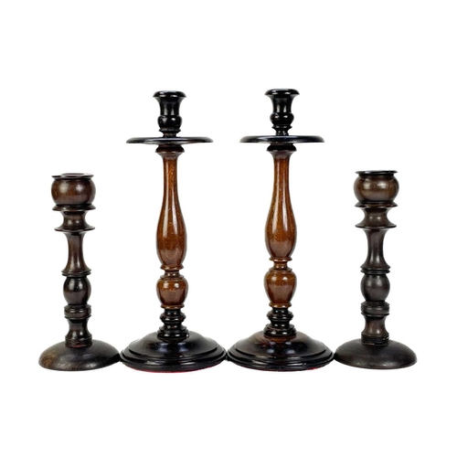 260 - A collection of nine treen candlesticks. Tallest 34cm. (9) Generally good condition with no breaks o... 