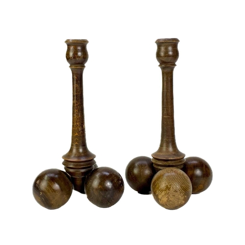 260 - A collection of nine treen candlesticks. Tallest 34cm. (9) Generally good condition with no breaks o... 