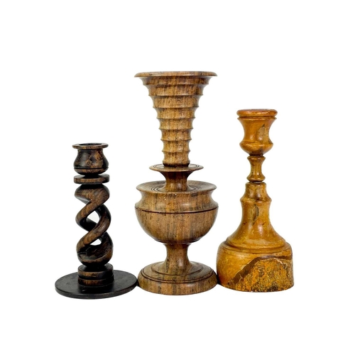 260 - A collection of nine treen candlesticks. Tallest 34cm. (9) Generally good condition with no breaks o... 