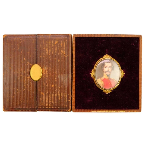 266 - English school, early 19th century. An oval portrait miniature of an officer, in an ornate gold fram... 