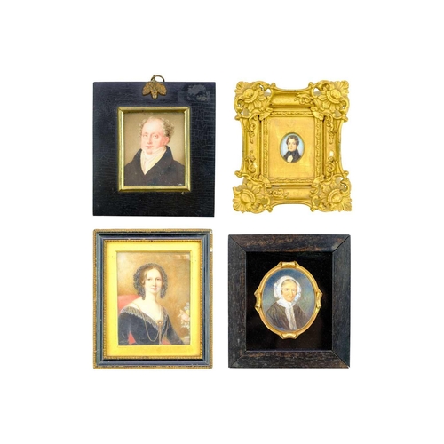 267 - A group of four 19th century miniature portraits. A lady, wearing a lace-trimmed dress and an ornate... 