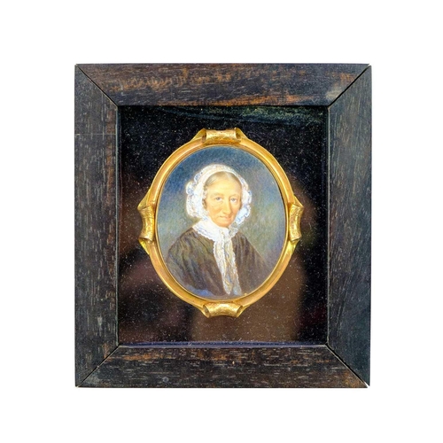 267 - A group of four 19th century miniature portraits. A lady, wearing a lace-trimmed dress and an ornate... 