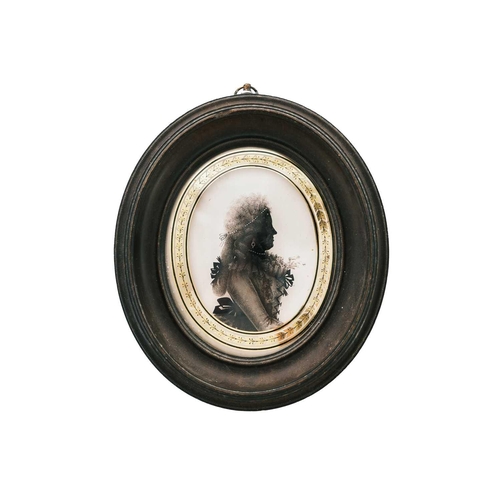 274 - Isabella Beetham (C.1753-1825). A painted silhouette oval portrait miniature of a lady, reverse pain... 