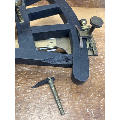 288 - An ebony and brass octant. Circa 1850, height 29cm, in a mahogany stow case, with labels for Chas W.... 