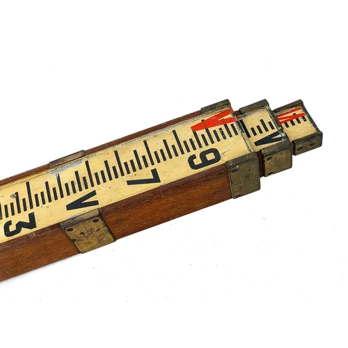 299 - A mahogany and brass bound telescopic surveyor's staff. With original painted scale, height (retract... 