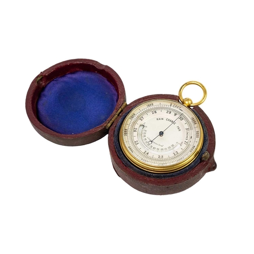 303 - A late 19th century gilt brass pocket aneroid barometer. With a silvered dial and curved mercury tub... 