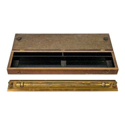 304 - A military brass parallel rolling rule. Stamped Pat No 160100, length 46cm, in stained wood case.