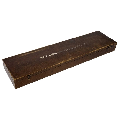 304 - A military brass parallel rolling rule. Stamped Pat No 160100, length 46cm, in stained wood case.