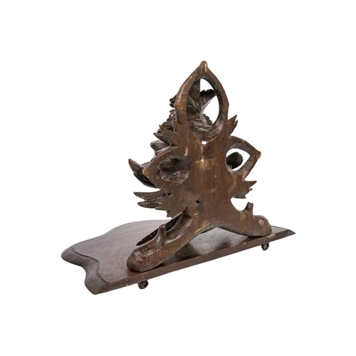 31 - A Black Forest carved wall bracket. Decorated with two birds amongst foliage, height 26cm.