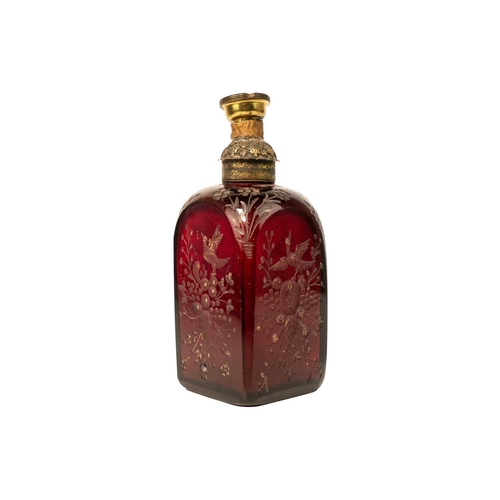 332 - An early 18th century ruby glass decanter, etched with exotic birds, flowers and foliage. Surmounted... 