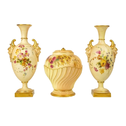 334 - A pair of Royal Worcester blush ivory vases. With pan mask handles and pedestal bases, shape number ... 