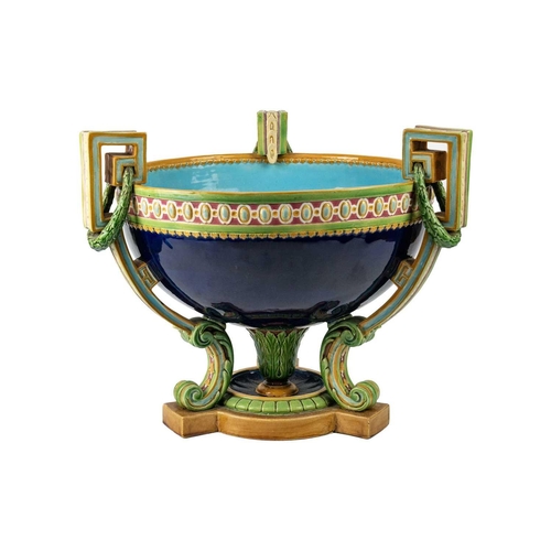 336 - A Minton Majolica punch bowl. Of Neo-Classical form, with three supports, moulded ornament, the exte... 