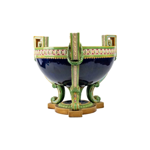 336 - A Minton Majolica punch bowl. Of Neo-Classical form, with three supports, moulded ornament, the exte... 