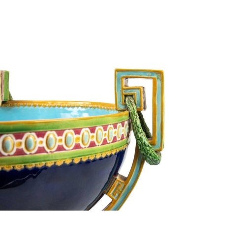 336 - A Minton Majolica punch bowl. Of Neo-Classical form, with three supports, moulded ornament, the exte... 