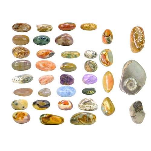 34 - A collection of polished minerals. To include; Petrified wood, blue calcite, polychrome jasper, ocea... 