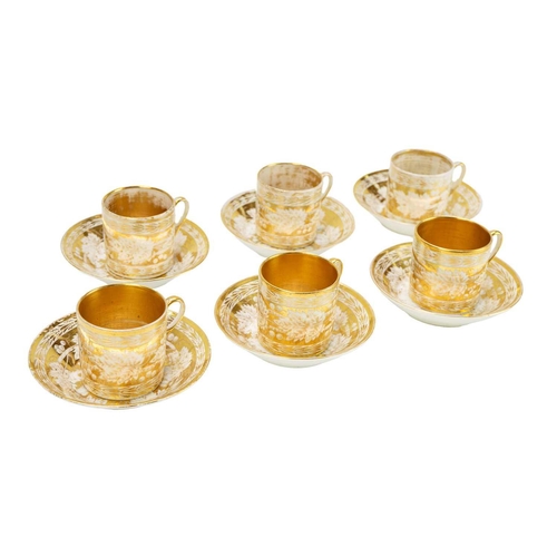 388 - A set of six gilt decorated coffee cans and saucers. Possibly Coalport, circa 1820, decorated with f... 