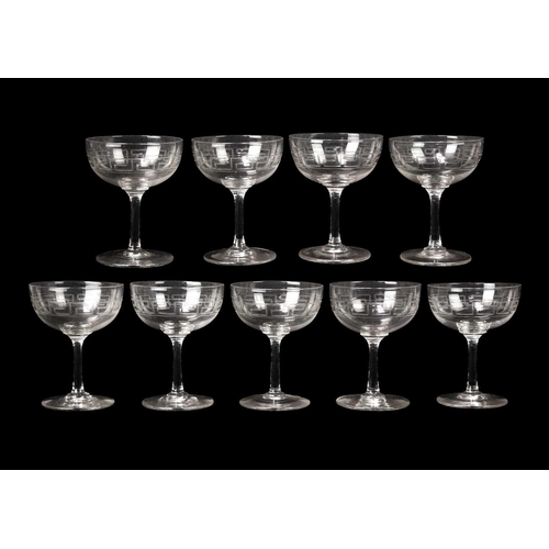 389 - A set of nine Edwardian glass champagne tazzae. With deeply engraved Greek Key borders, height 12cm.... 