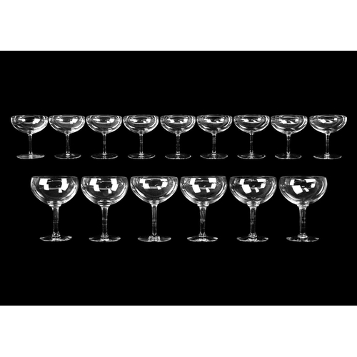 399 - A suite of eleven champagne coupes. Height 10.75cm, together with a set of eight large champagne cou... 