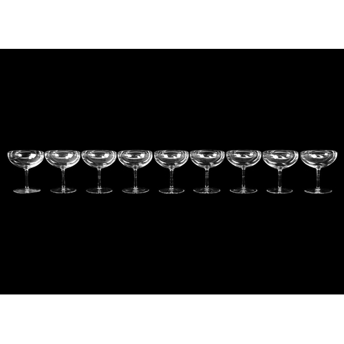 399 - A suite of eleven champagne coupes. Height 10.75cm, together with a set of eight large champagne cou... 