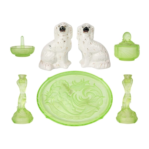 406 - A 1930s uranium glass dressing table set. Comprising a pair of mermaid candlesticks, an oval tray wi... 