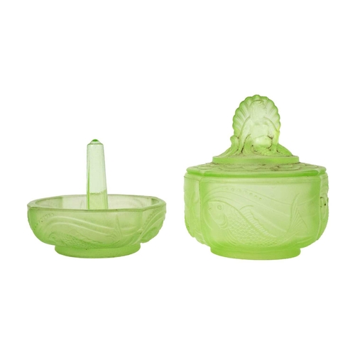 406 - A 1930s uranium glass dressing table set. Comprising a pair of mermaid candlesticks, an oval tray wi... 