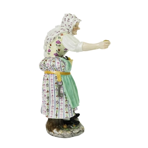 410 - A late 19th century Meissen porcelain figure of an apple seller. Crossed swords and impressed 977 ma... 