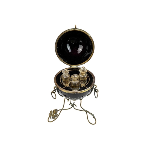 412 - A Victorian enamelled black glass scent bottle holder. Of hinged spherical form painted with a peaco... 