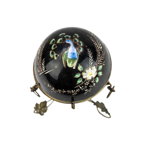 412 - A Victorian enamelled black glass scent bottle holder. Of hinged spherical form painted with a peaco... 