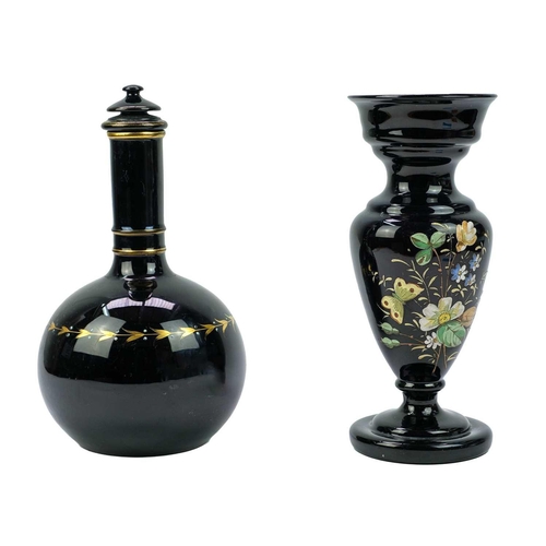 416 - An aesthetic movement pottery bottle vase and cover. In black glaze and highlighted in gilt, height ... 