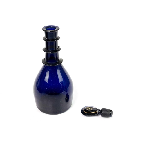 417 - A 19th century Bristol Blue glass rum decanter. With triple ring neck, and initialled stopper. Heigh... 