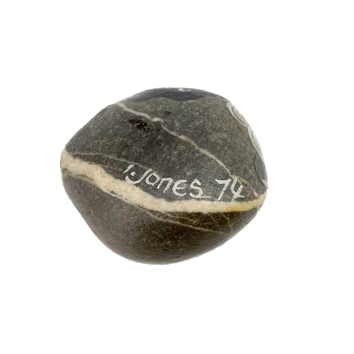 42 - Irene Jones (1938) A pebble painted with a female mask, signed and dated '74, length 5cm, together w... 