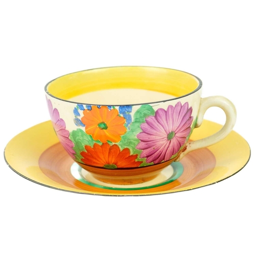 420 - A Clarice Cliff Gay Day pattern tea cup and saucer. Bizarre Newport marks. A hairline crack to the h... 