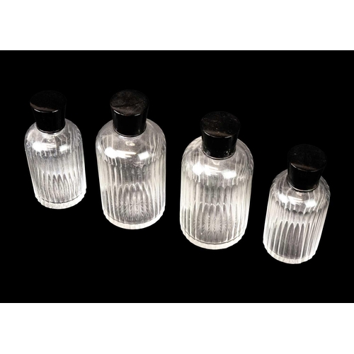 433 - A pair of Art Deco cut glass scent bottles and stoppers. With fluted decoration and black celluloid ... 