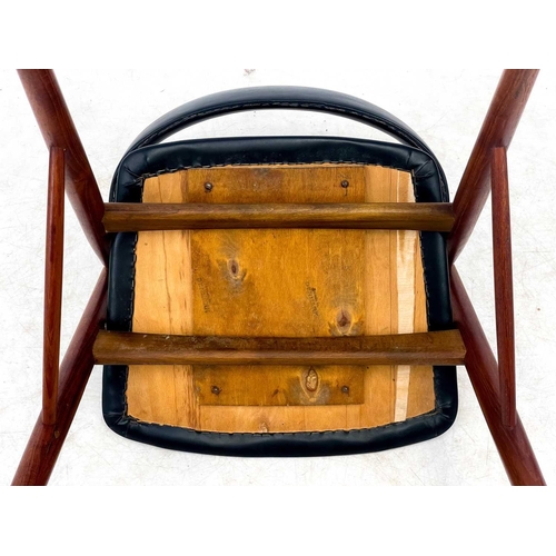 453 - A mid century Danish teak elbow chair. With black vinyl padded back and seat, on turned supports, he... 