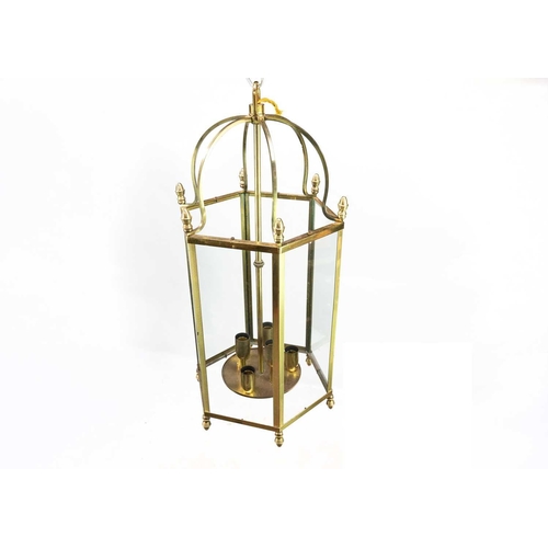 469 - A glazed brass hexagonal hall lantern. Later 20th century, each with six lamps, height 73cm (2).