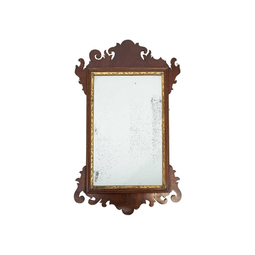 471 - A George III mahogany fretwork wall mirror. The rectangular plate with a moulded gilt slip, height 6... 