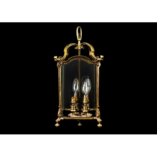 472 - A brass four light hall lantern. 20th century, fitted three (of four) plain glass panels, with turne... 