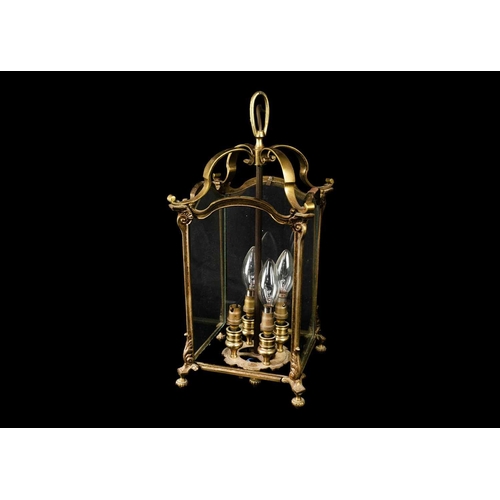 472 - A brass four light hall lantern. 20th century, fitted three (of four) plain glass panels, with turne... 