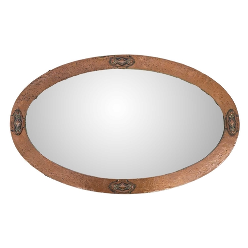 475 - An Arts and Crafts copper frame oval mirror. 83cm x 51cm.