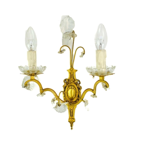 477 - A pair of gilt metal twin branch wall lights. 20th century, with cut glass shell, spear and pendant ... 