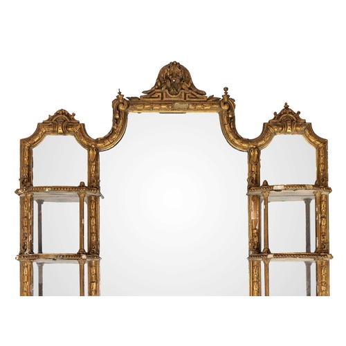 482 - A late Victorian gilt gesso wall mirror. The central plate flanked by shaped shelves, with turned an... 