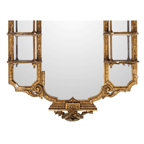 482 - A late Victorian gilt gesso wall mirror. The central plate flanked by shaped shelves, with turned an... 