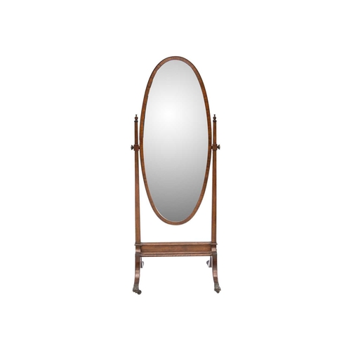 486 - An Edwardian mahogany oval cheval mirror. With urn finials, on swept supports with brass paw castors... 