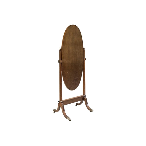 486 - An Edwardian mahogany oval cheval mirror. With urn finials, on swept supports with brass paw castors... 